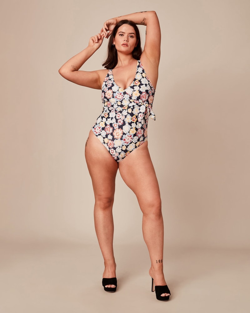 Front of a model wearing a size 1X Kelly Wrap One-Piece in BLUE by Tanya Taylor. | dia_product_style_image_id:228009
